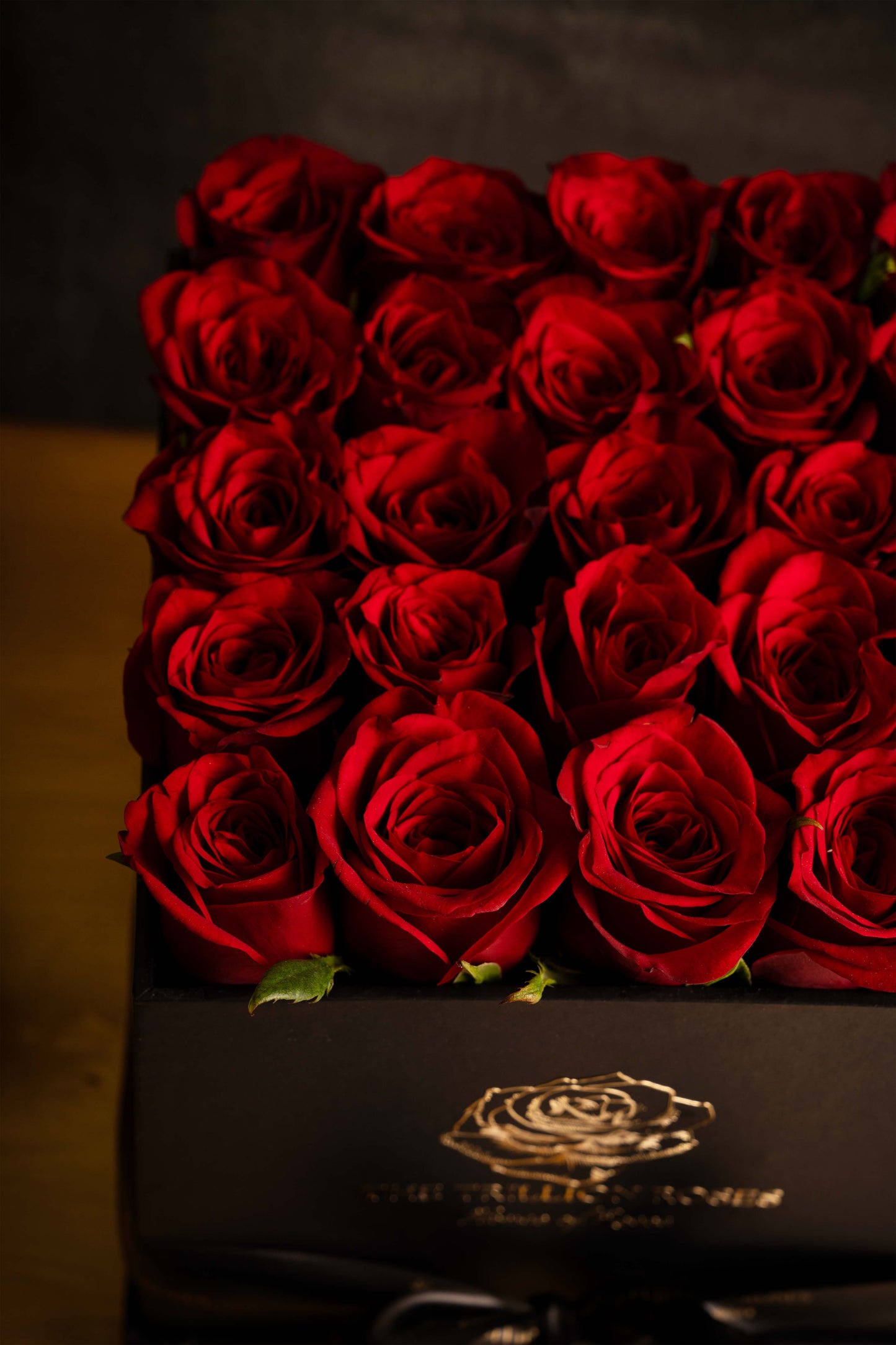 RUBY RED ROSES IN BLACK SQUARE BOX.