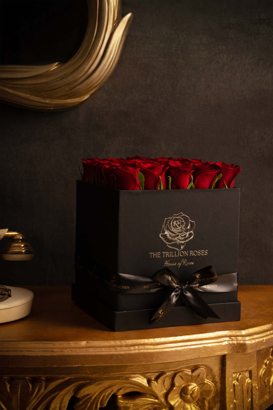 RUBY RED ROSES IN BLACK SQUARE BOX.