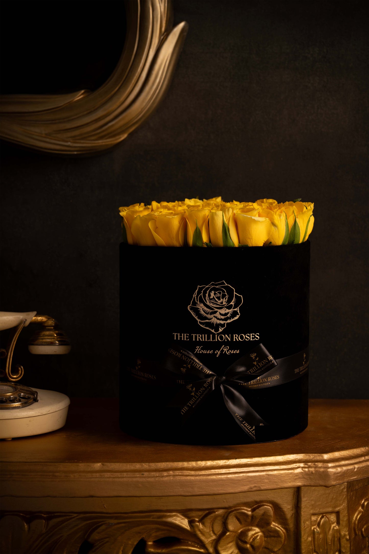 YELLOW SUNSHINE - YELLOW ROSES IN BLACK ROUND BOX.