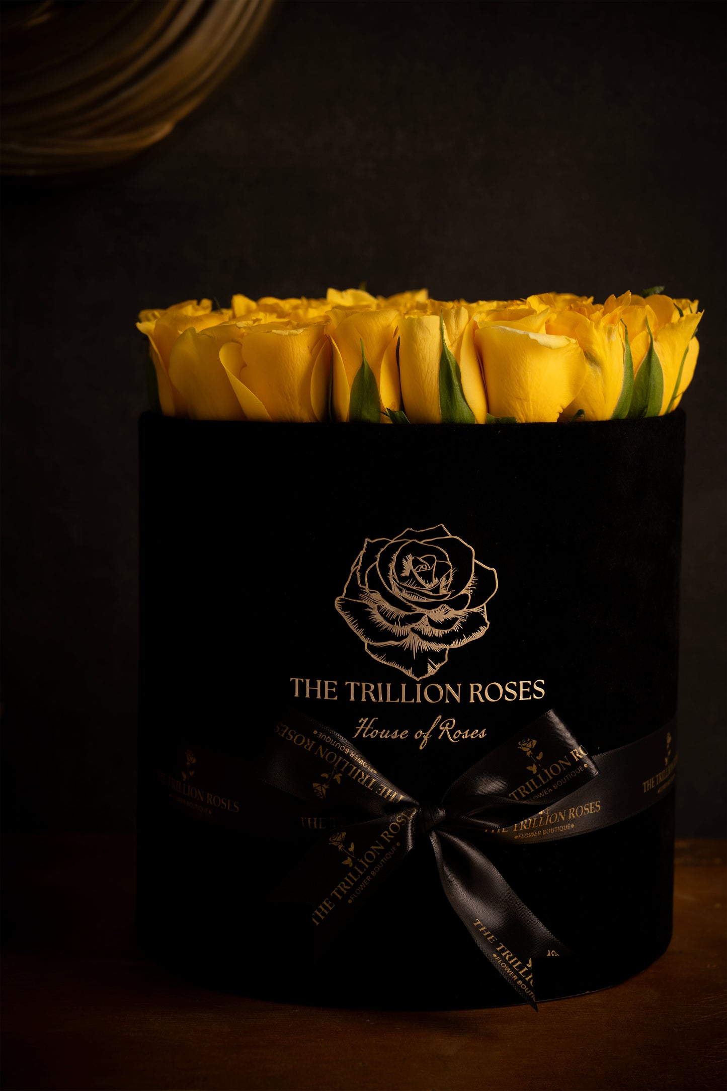 YELLOW SUNSHINE - YELLOW ROSES IN BLACK ROUND BOX.